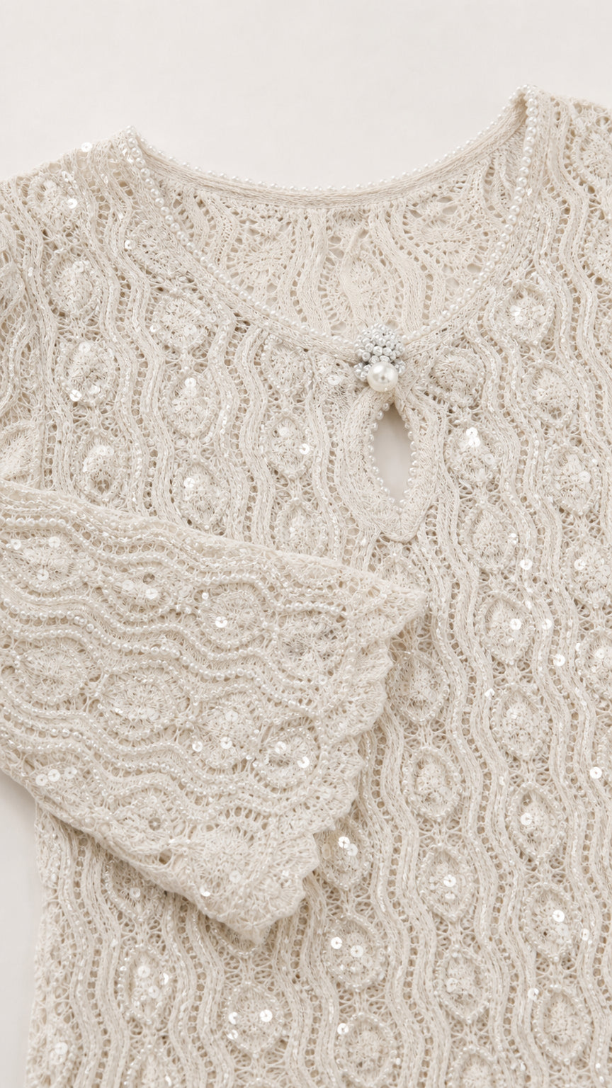 Close-up of fabric texture and keyhole neckline on white dress