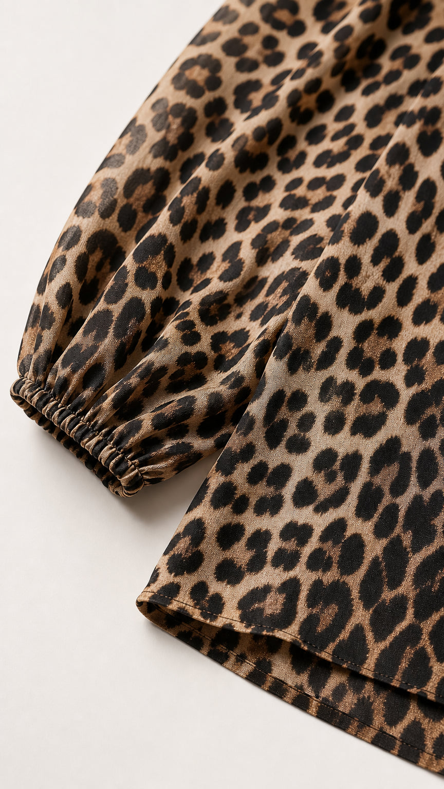 Close-up detail of the sleeve cuff and leopard print fabric texture