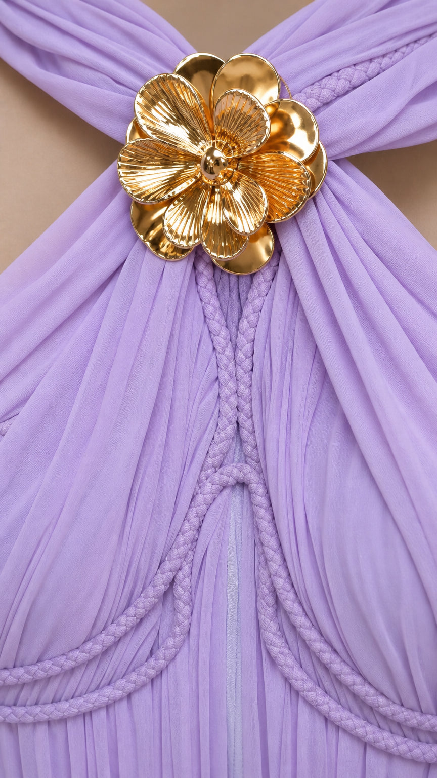 Close-up of gold metallic floral accent on lavender dress