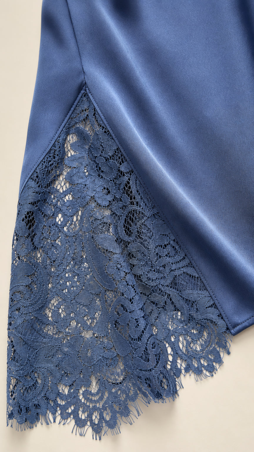 Close-up detail of lace hem insert on satin dress
