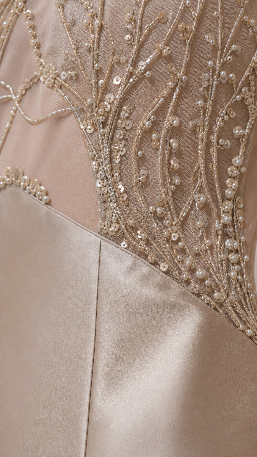 Close-up detail of intricate bead and sequin embroidery on mesh panel
