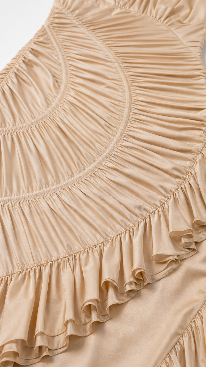 Close-up detail of fabric ruching and cascading ruffles