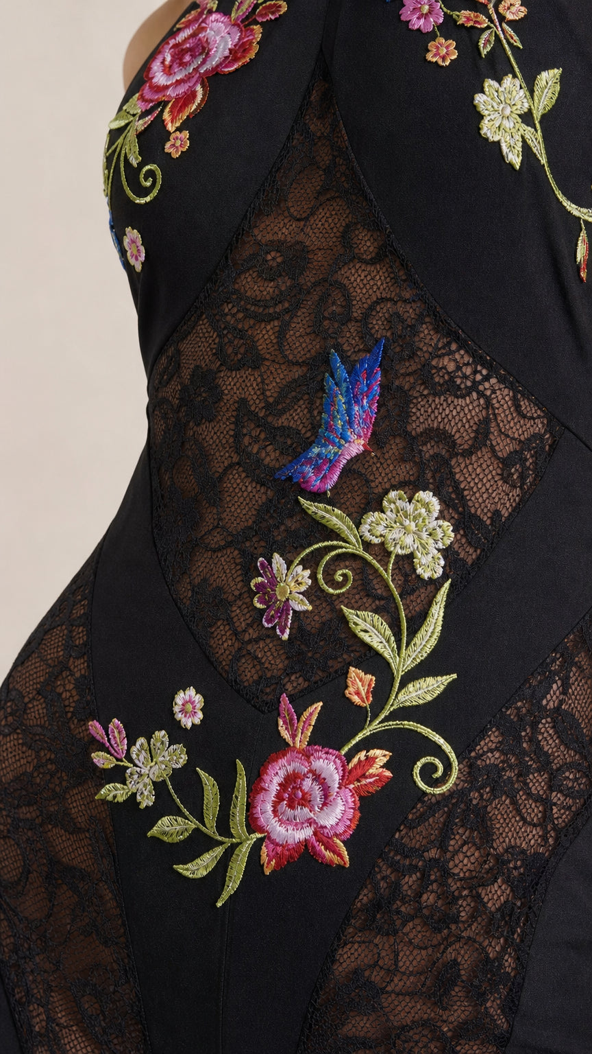 Close-up of bodice showing floral embroidery and lace panel details