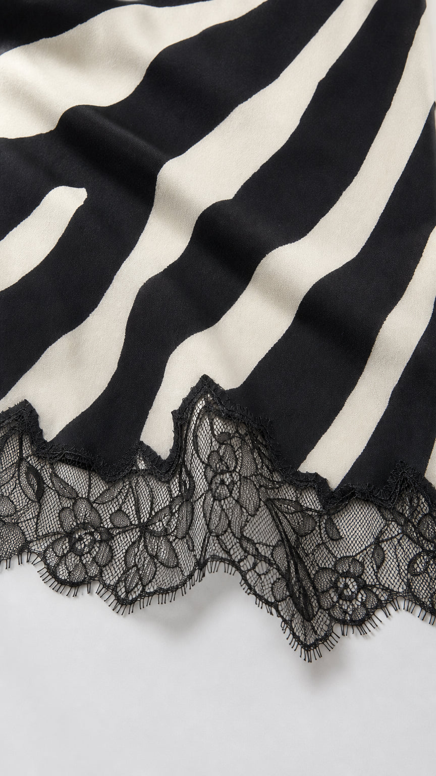 Close-up of the black and white zebra stripe fabric and scalloped lace hem