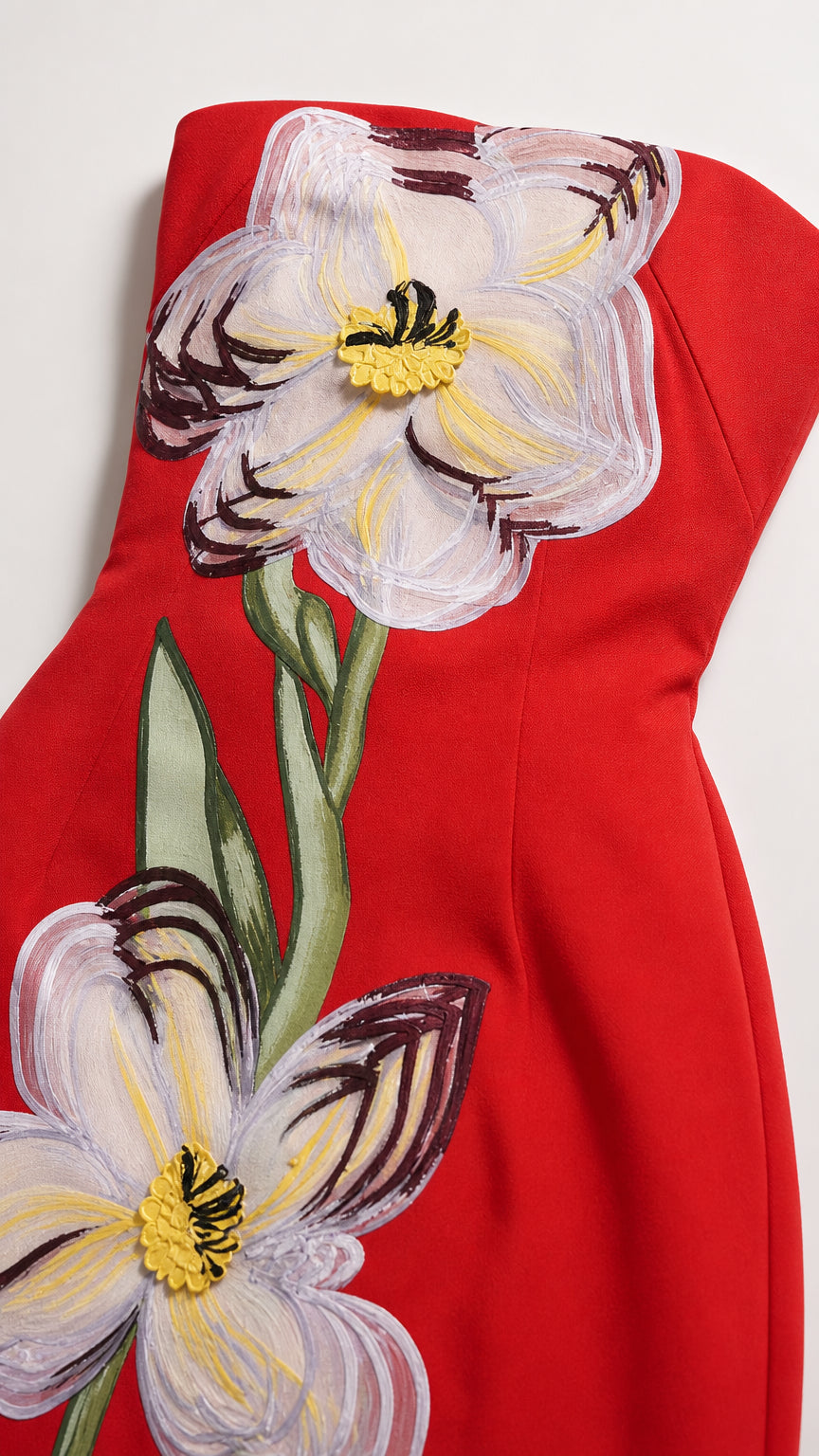 Close-up detail of floral applique on red dress