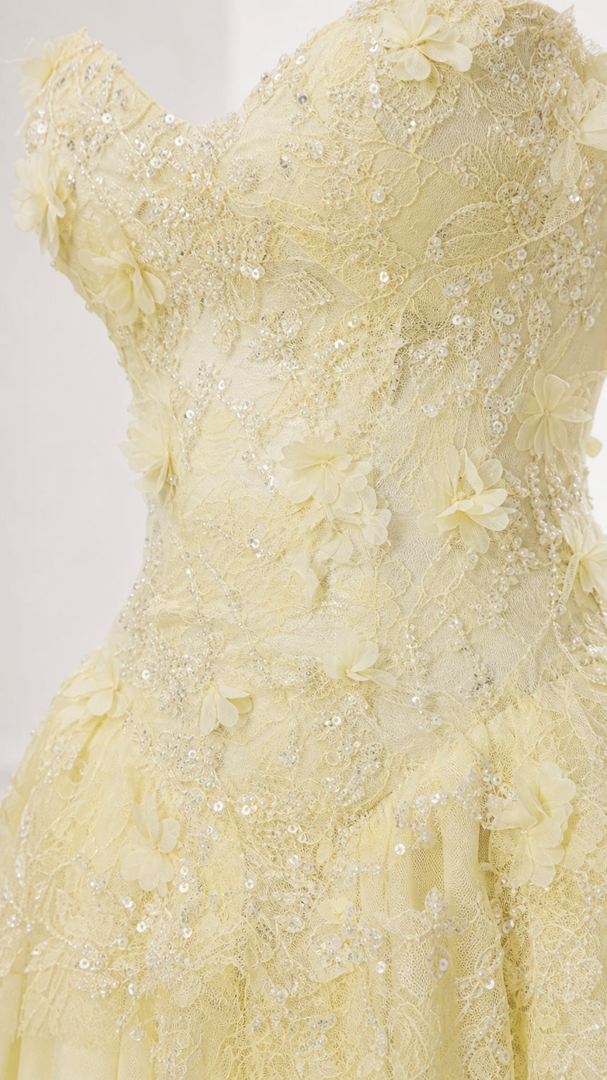 Close-up detail of 3D floral appliques on the yellow bodice