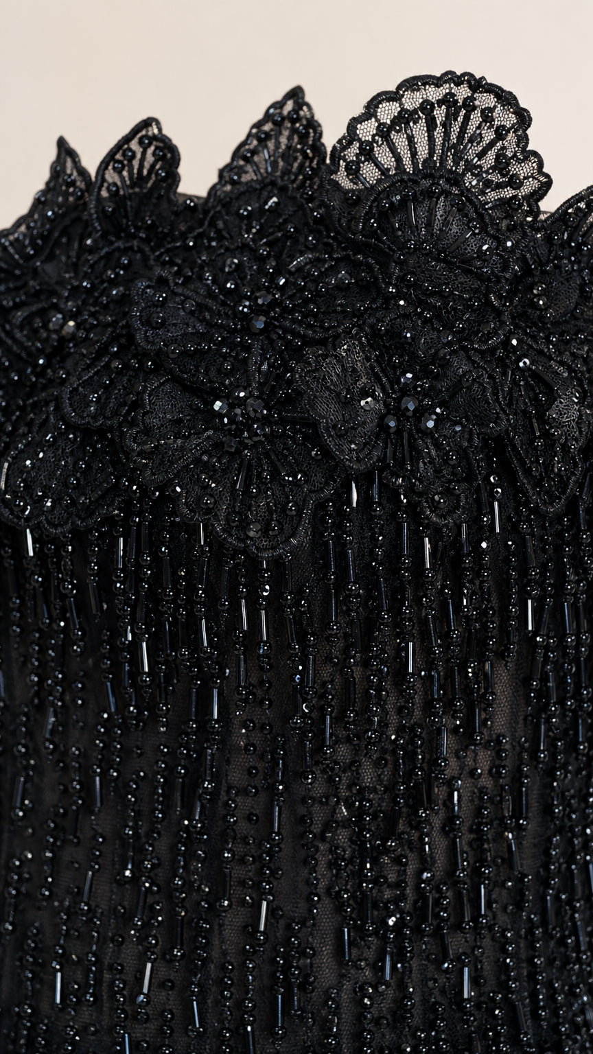 Close-up detail of 3D floral beaded neckline on black gown