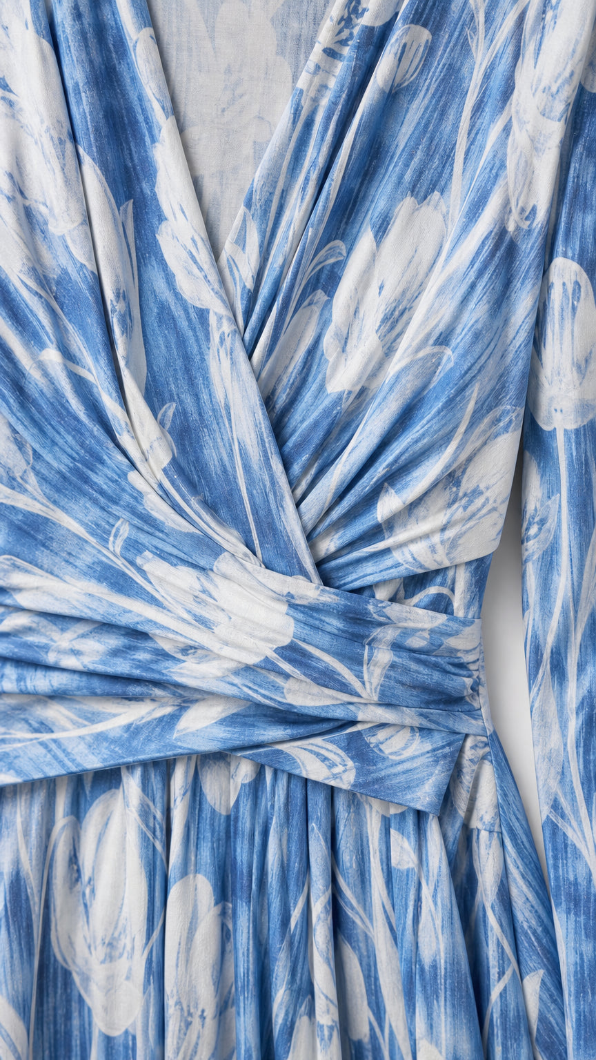 Close-up of fabric and wrap V-neck detail on blue floral dress