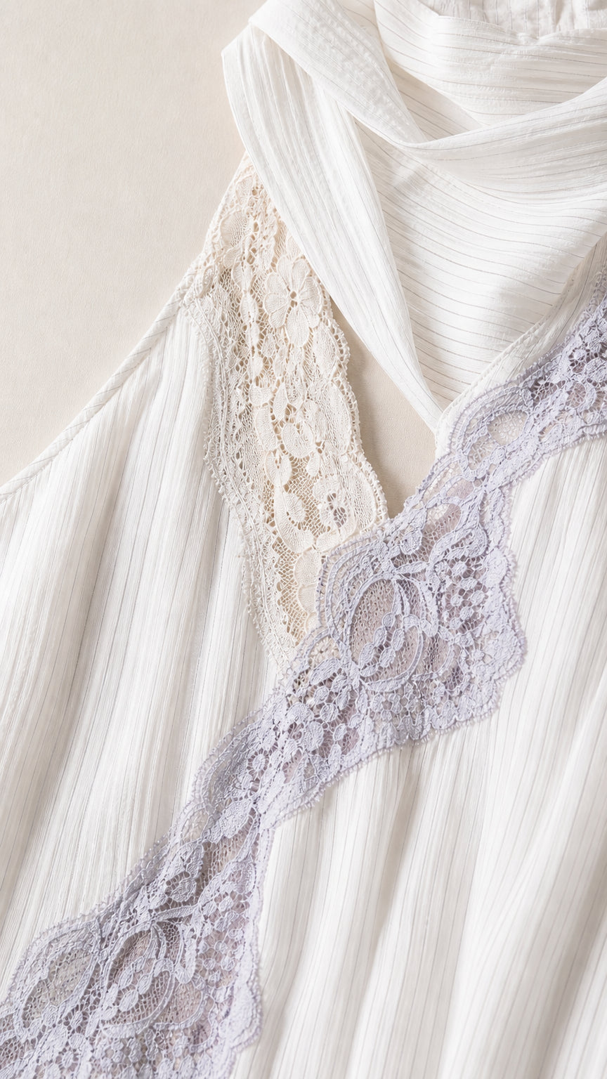 Close-up detail of diagonal lace trim on textured white fabric