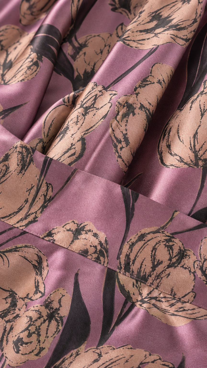 Close-up detail of the purple and metallic floral jacquard fabric