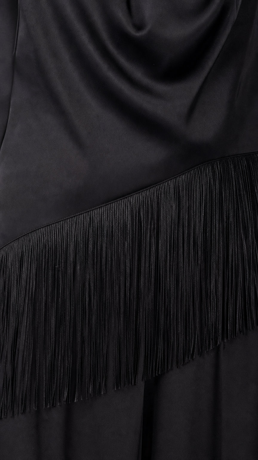Close-up detail of fringe trim on black satin jumpsuit