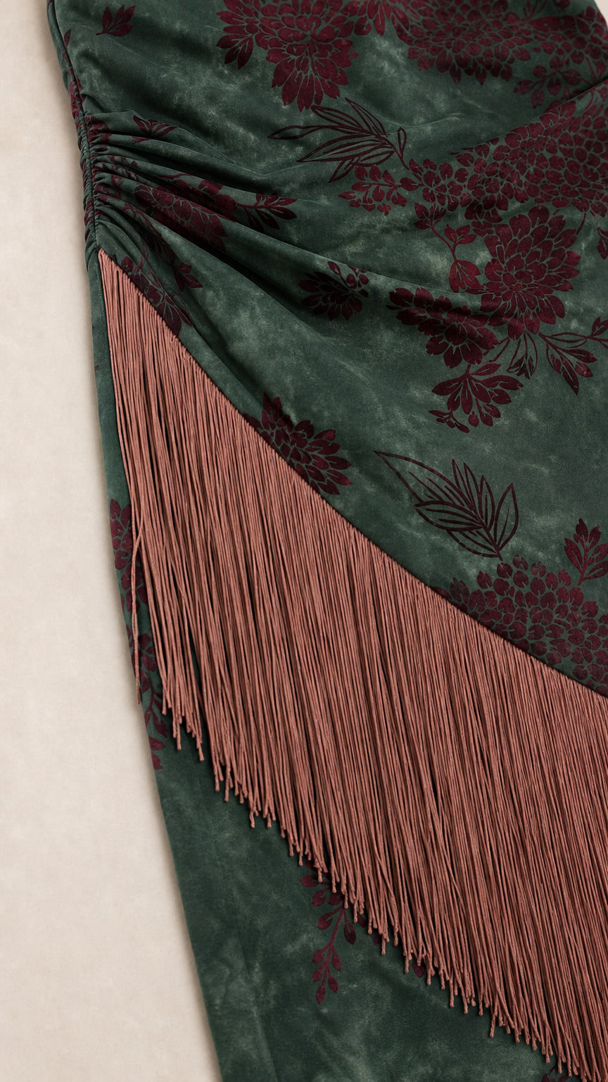 Close-up detail of floral velvet texture and fringe trim