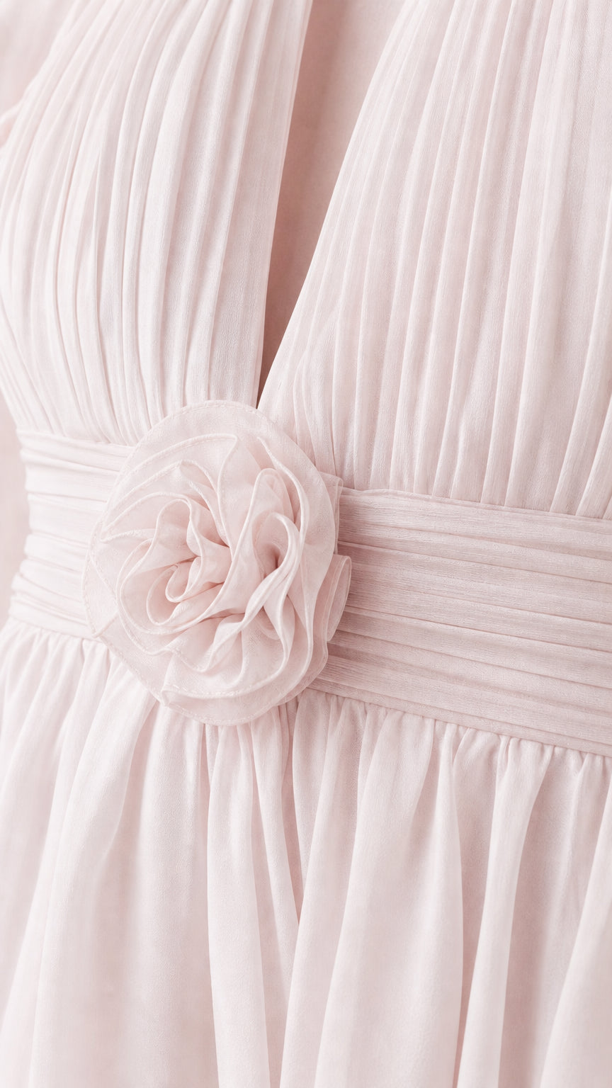 Close-up detail of front bodice rosette and chiffon pleats on pink dress
