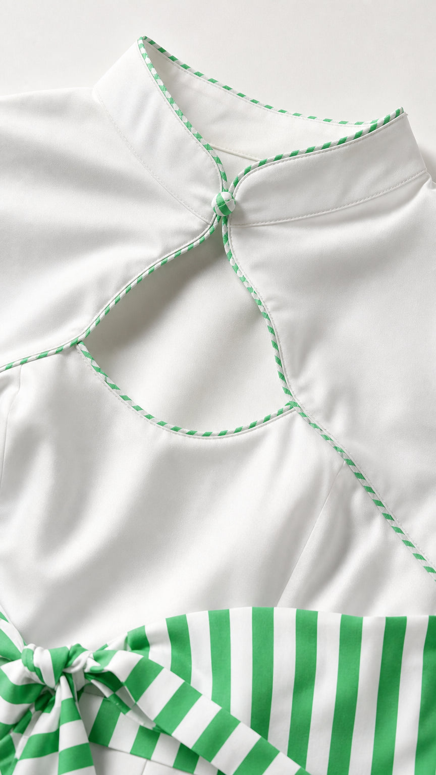 Close-up detail of mandarin collar, keyhole, and green piping