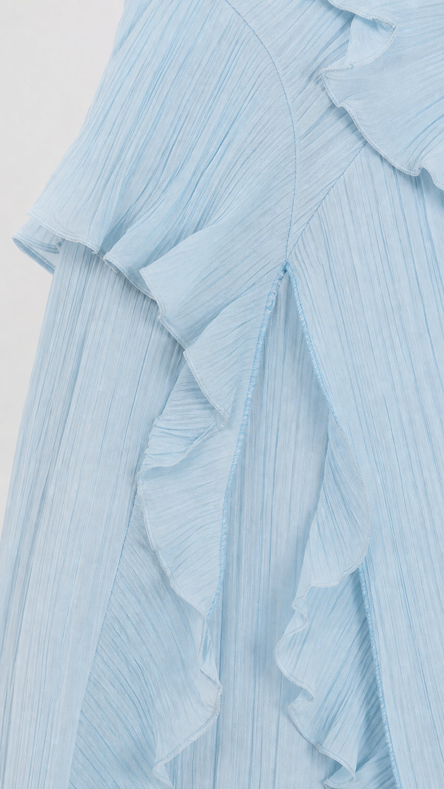 Close-up of lightweight pleated fabric and cascading ruffles in light blue