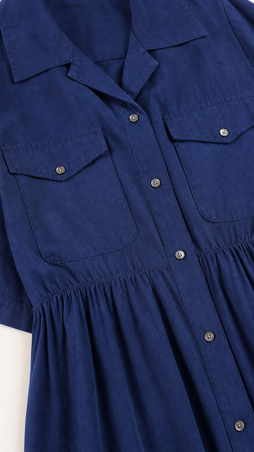 Close-up of collar, buttons, and chest pockets on navy blue dress