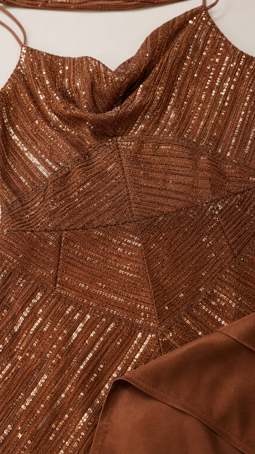 Close-up detail of geometric sequin texture and cowl neckline