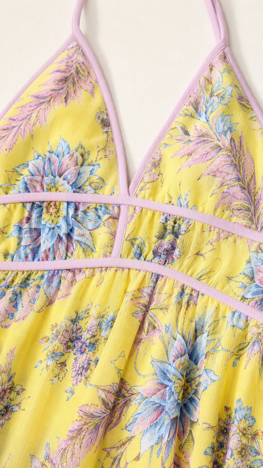 Close-up detail of yellow floral maxi dress neckline and piping