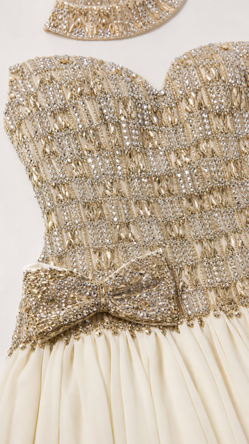 Close-up detail of rhinestone embellished bodice and side bow