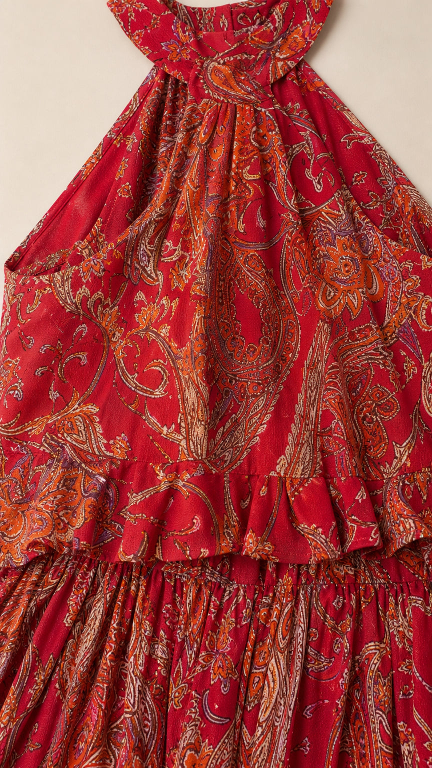 Close-up detail of the red paisley fabric and ruffle bodice