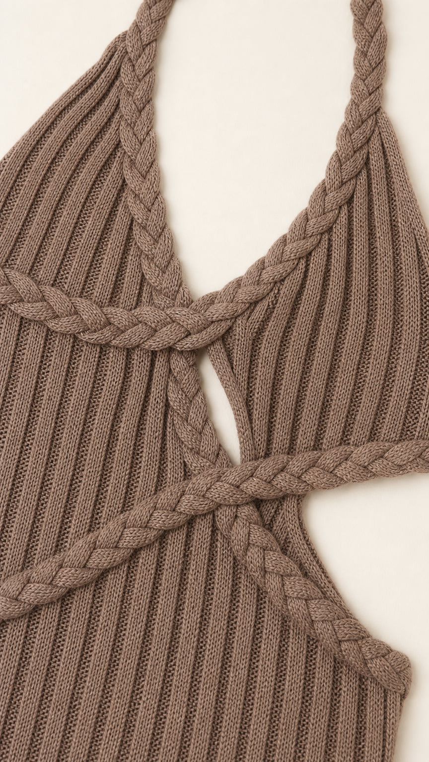 Close-up detail of braided strap and cutout design on brown dress