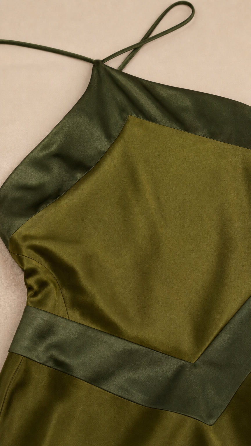 Close-up detail of halter neck and contrast panel on olive dress