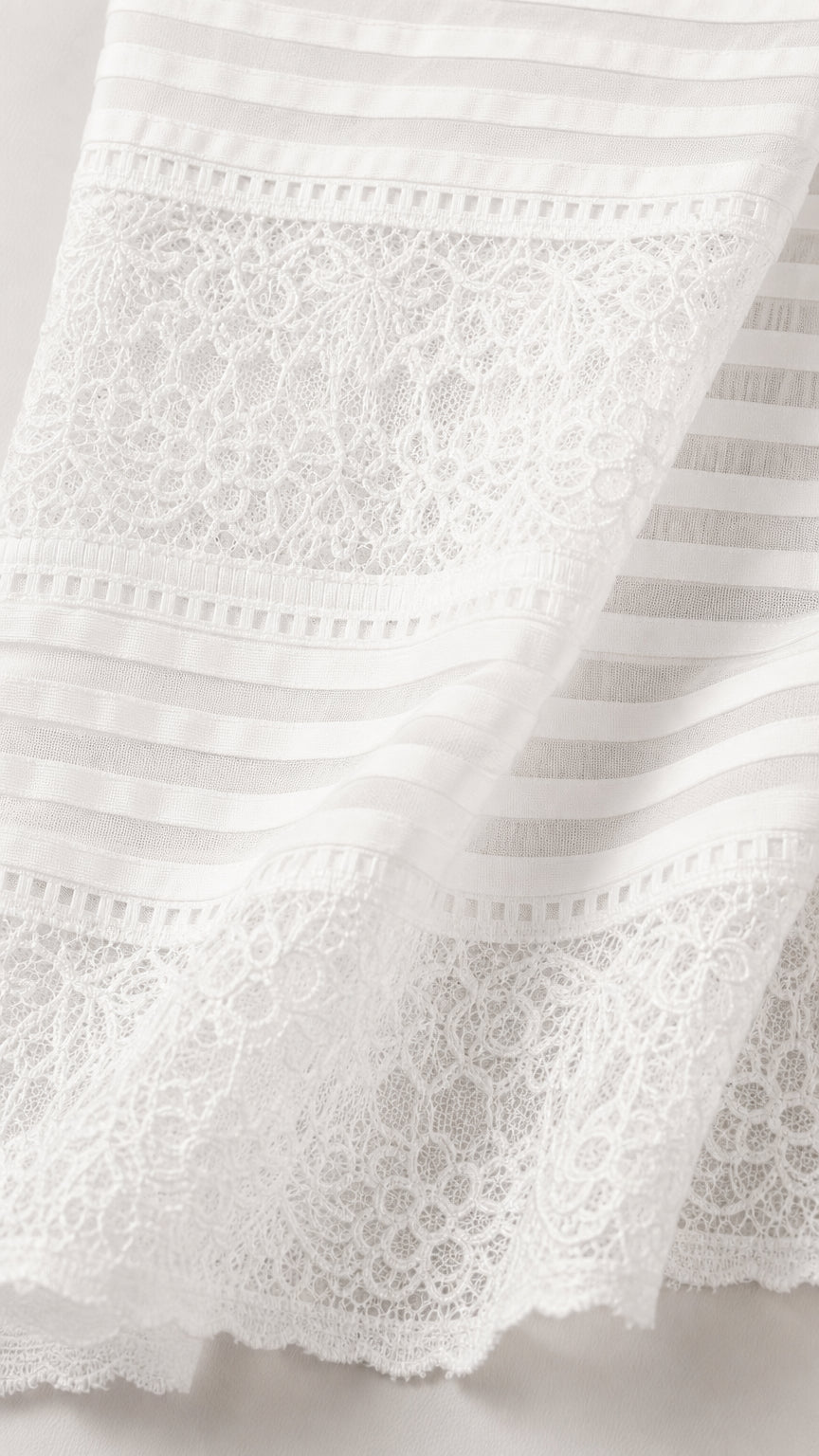 Close-up detail of white lace and striped fabric texture