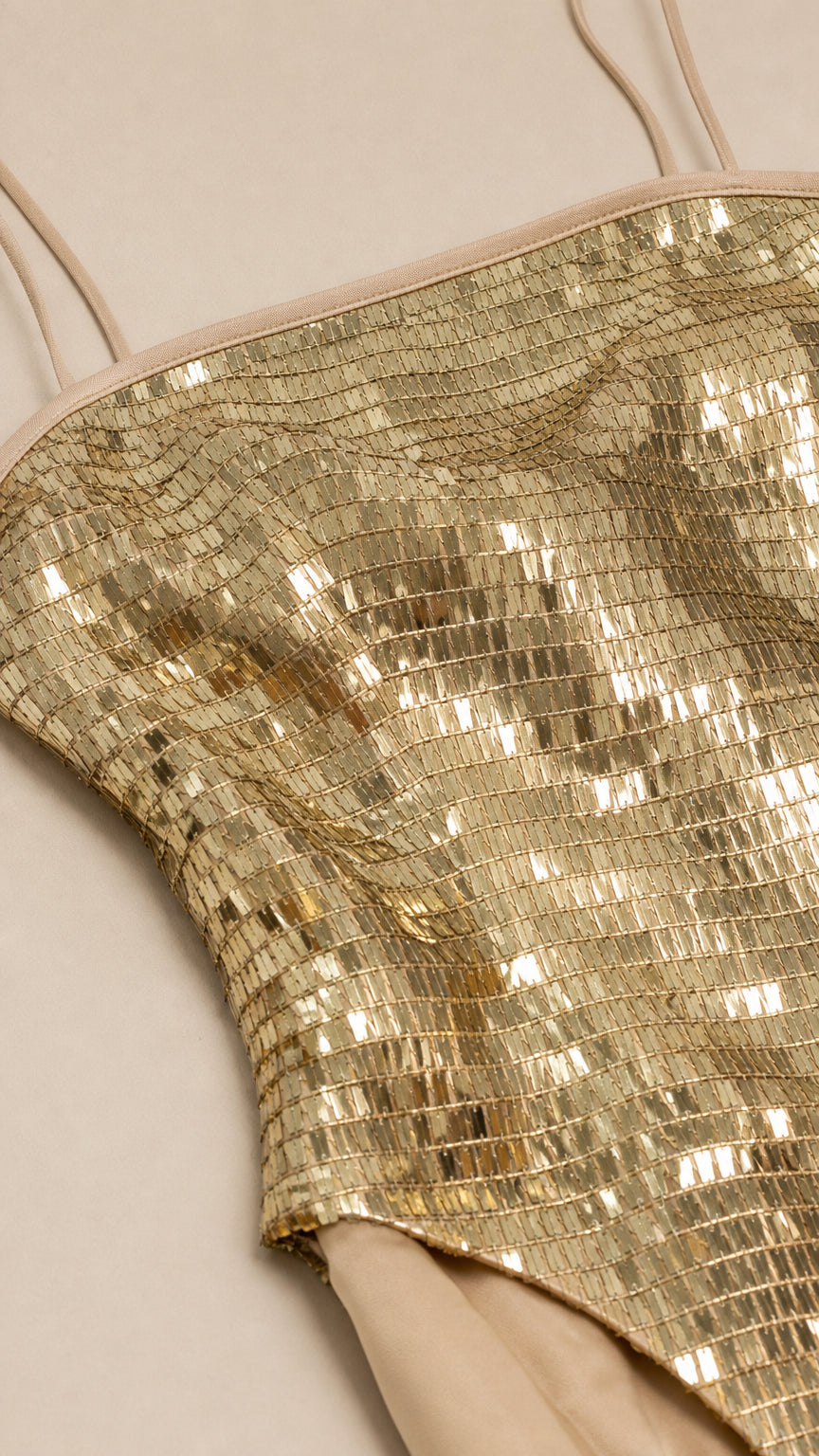 Close-up detail of square gold sequins and strap construction