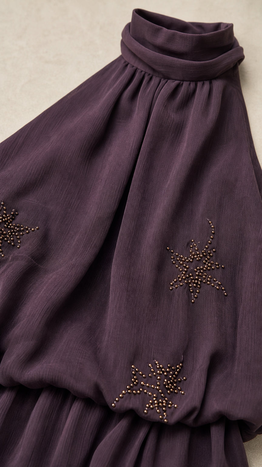 Close-up detail of star beadwork and gathered neckline on Dark Plum dress