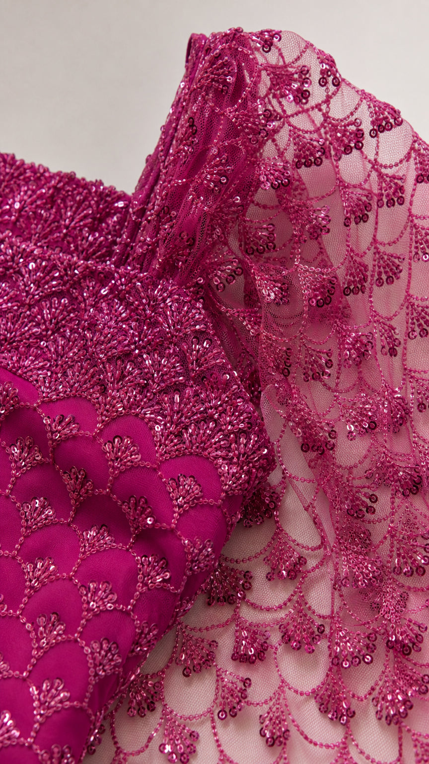 Close-up detail of fuchsia sequin and embroidered mesh fabric