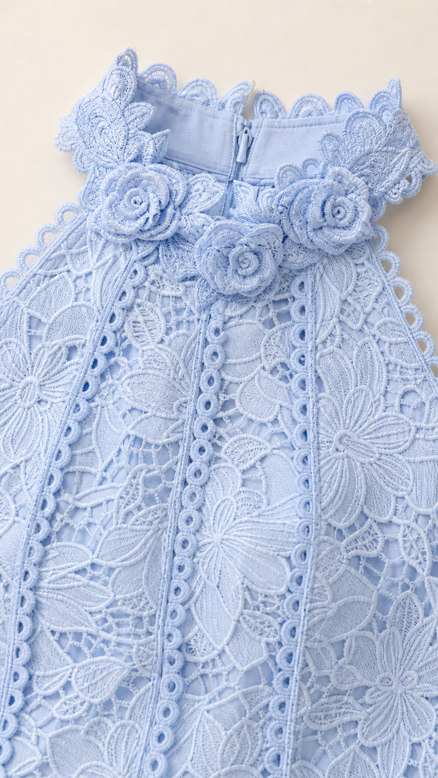 Close-up of light blue halter neckline and 3D floral lace details