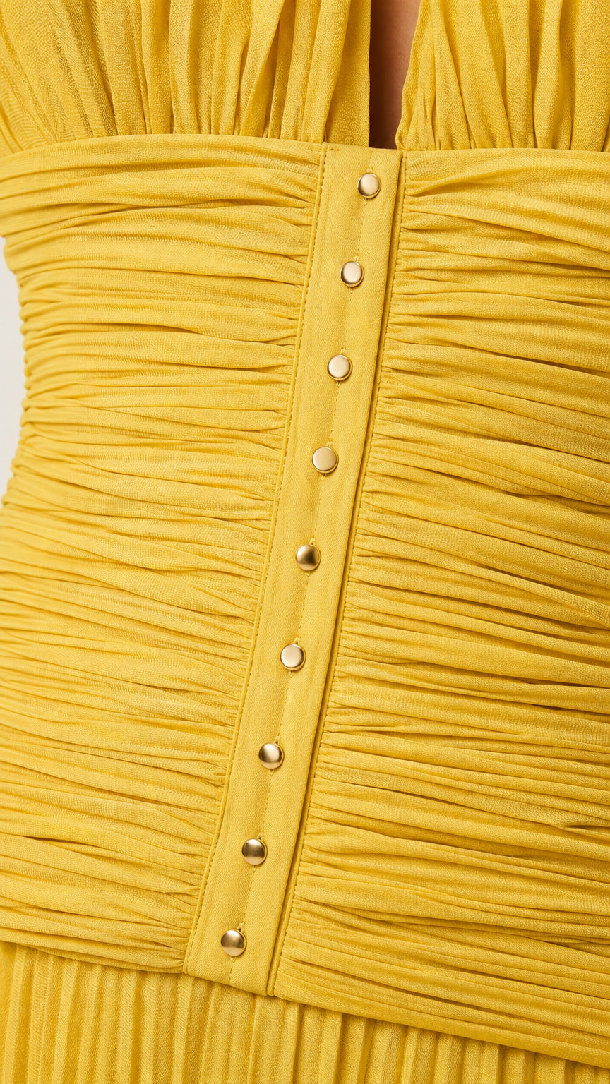 Close-up of ruched bodice and button details on yellow dress