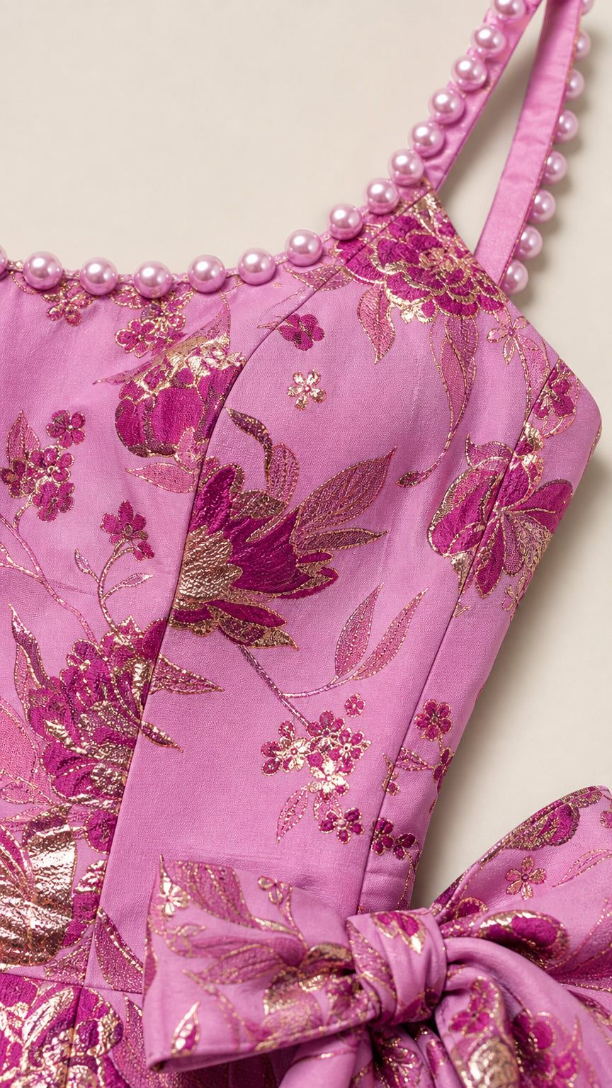 Close-up detail of pearl beaded straps and metallic pink brocade fabric