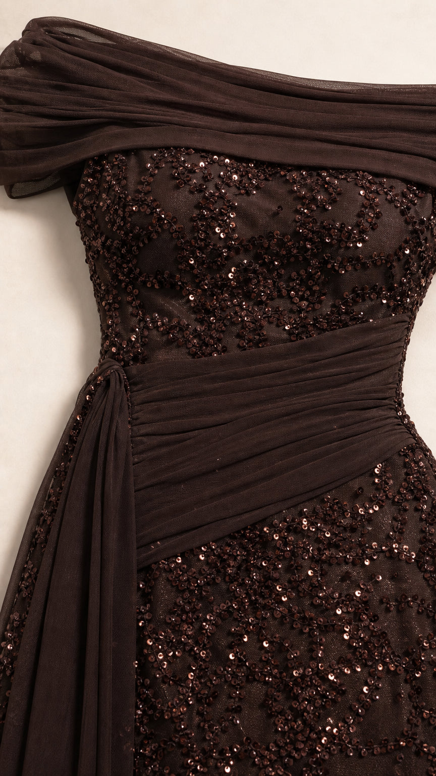 Close-up detail of draped off-shoulder neckline and sequin texture