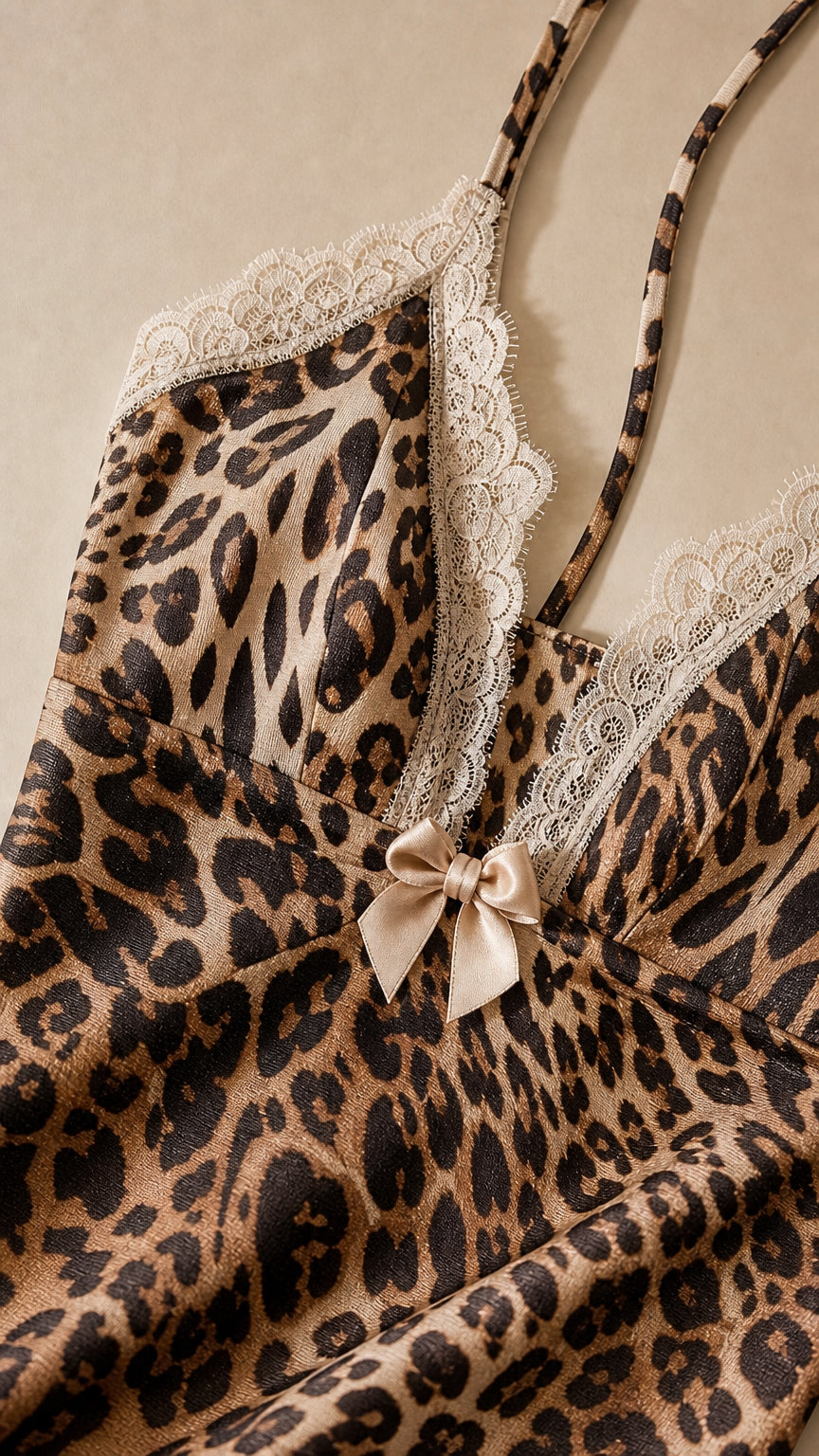 Close-up of lace trim and bow detail on leopard print dress