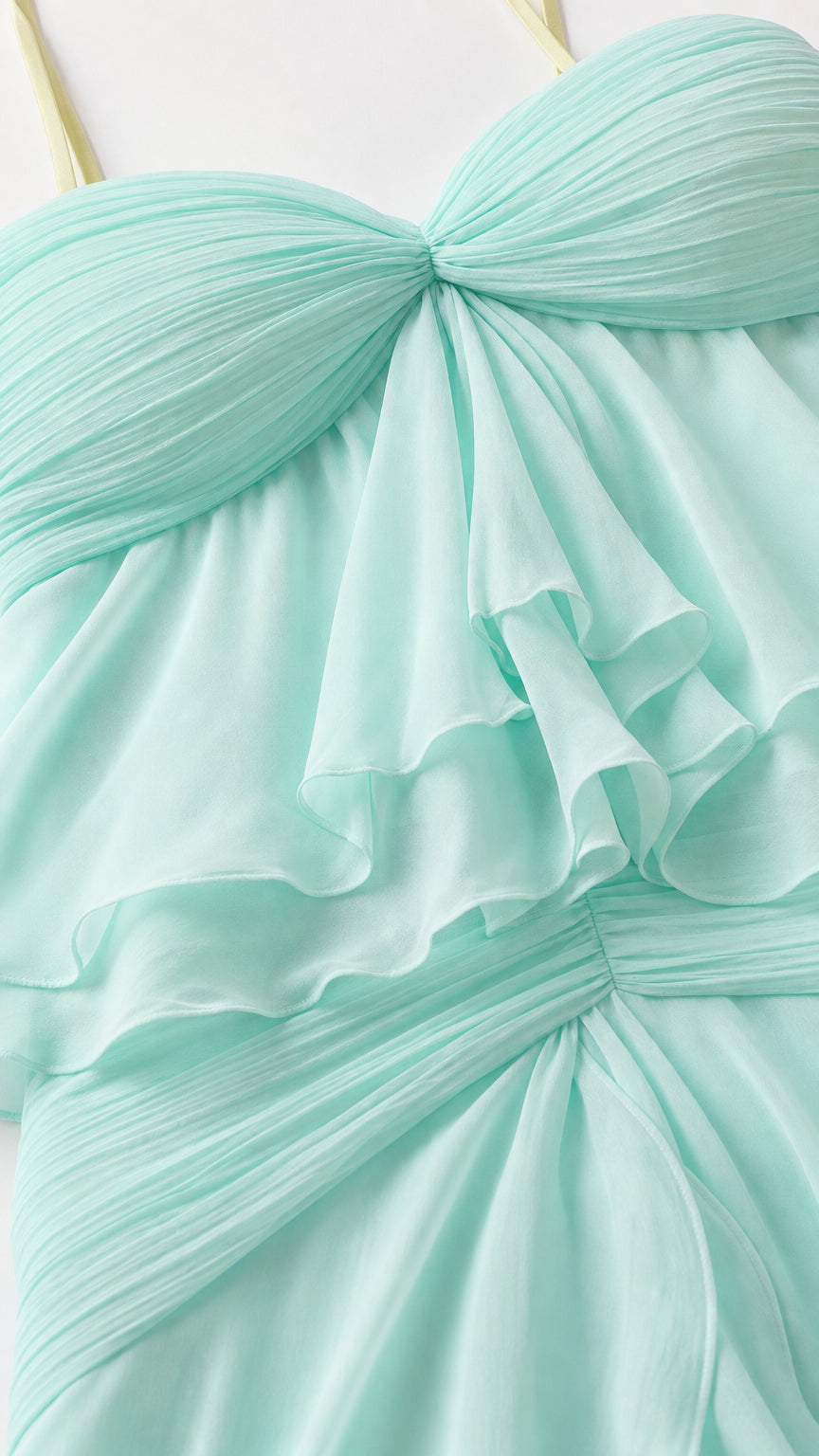Close-up detail of sweetheart neckline and ruffles on mint dress