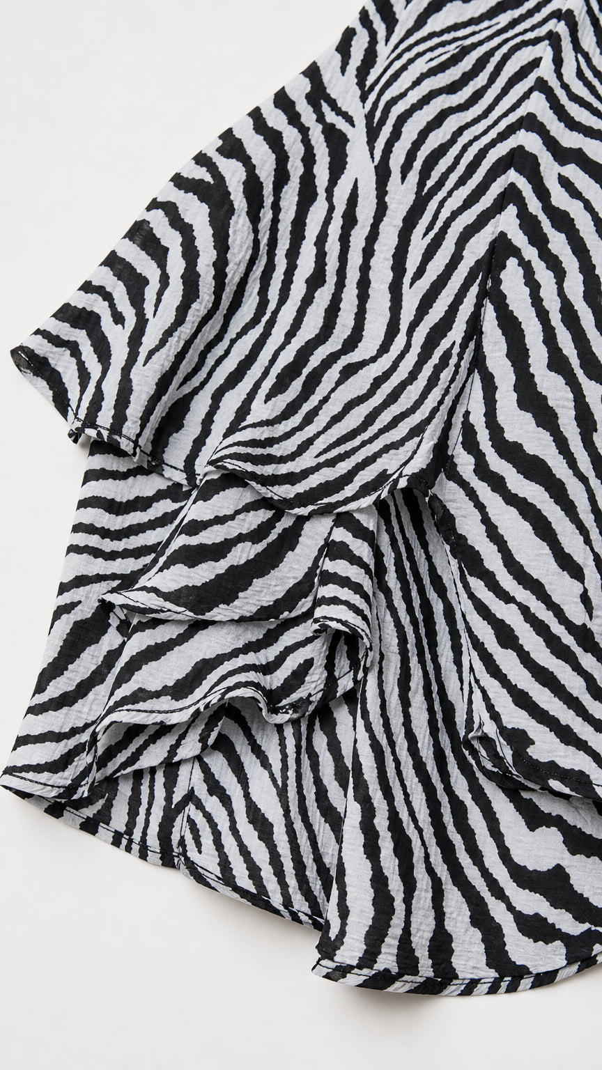 Close-up detail of layered ruffles on the zebra print fabric