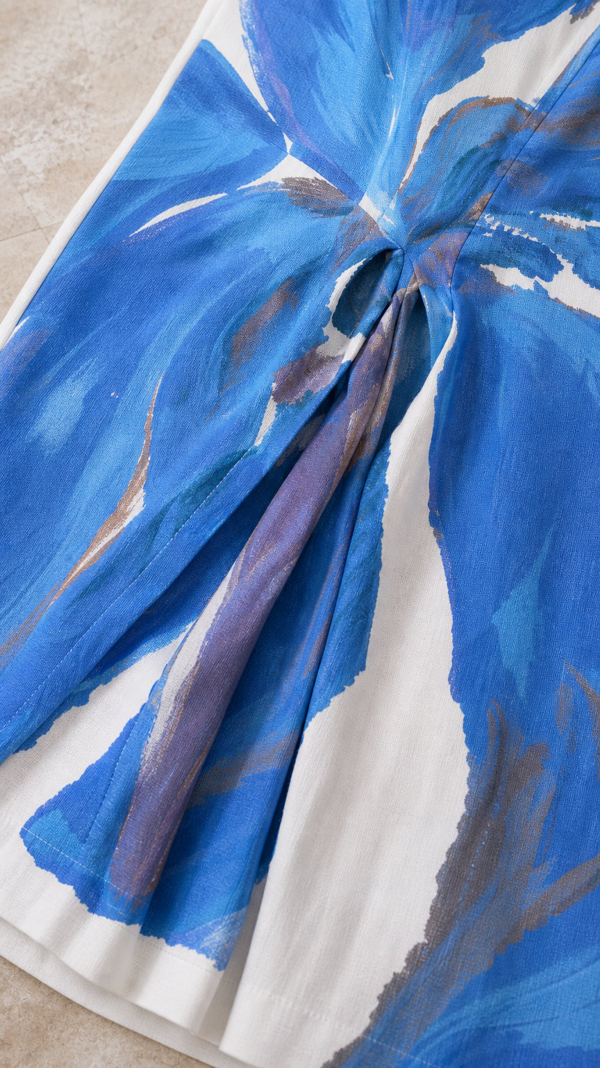 Close-up detail of blue and white floral fabric and draped gathering