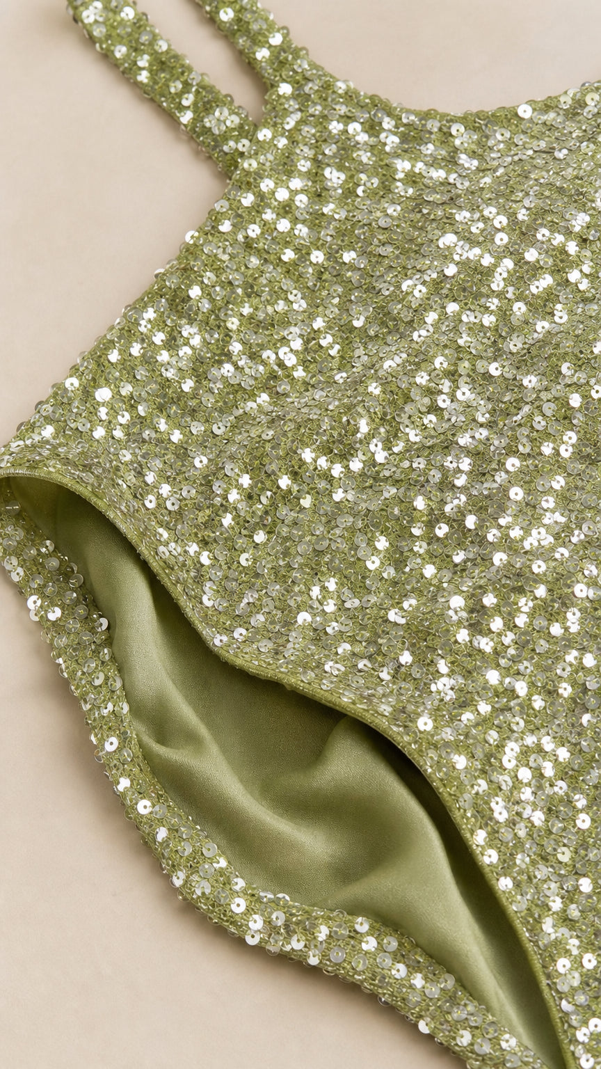 Close-up detail of sage green sequin fabric and inner lining