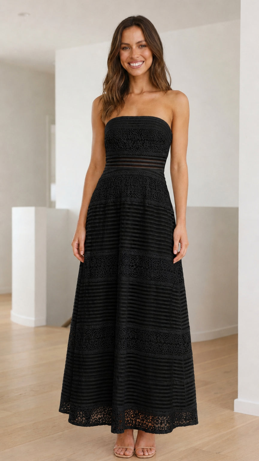 Model wearing black strapless lace maxi dress