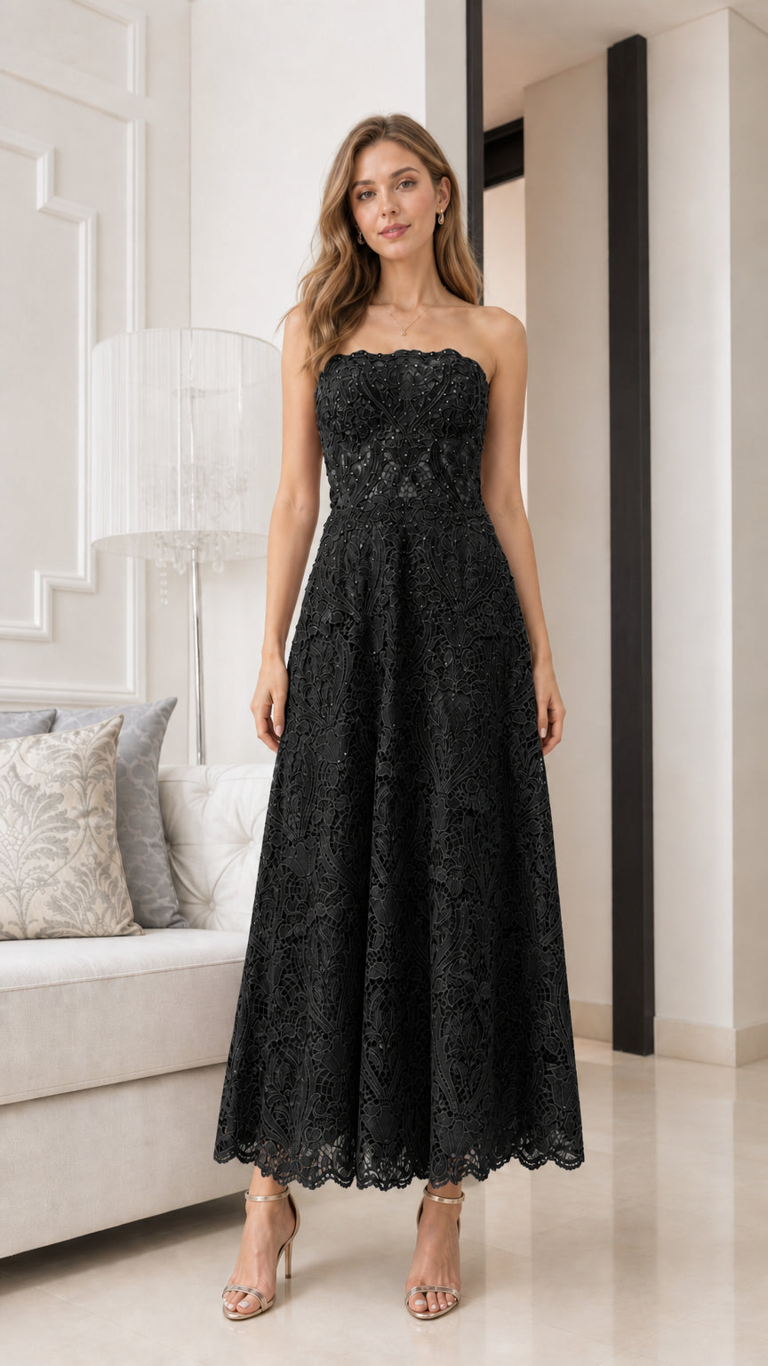 Front view of model wearing black strapless lace midi dress