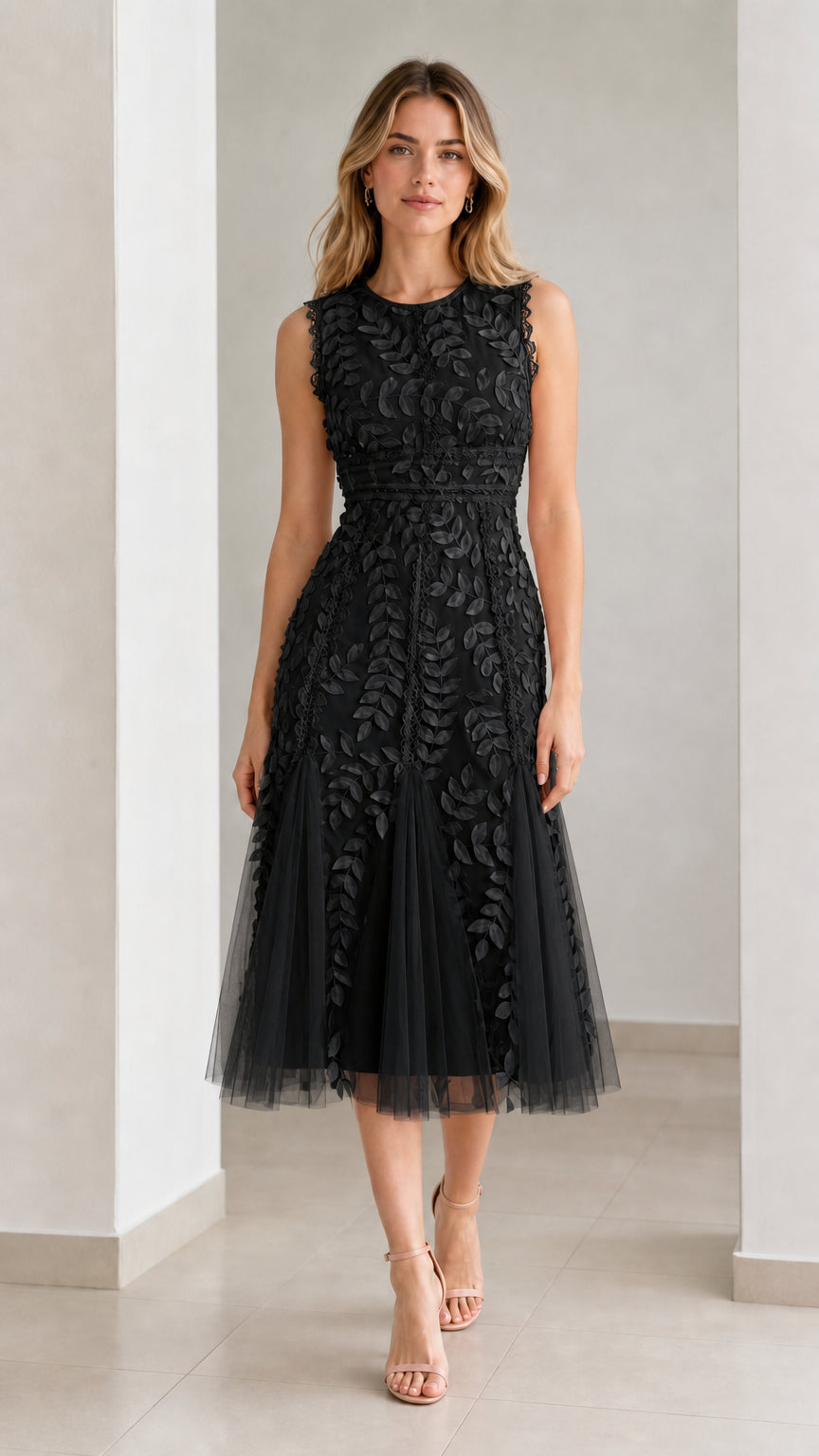 Front view of model wearing black embroidered leaf applique midi dress