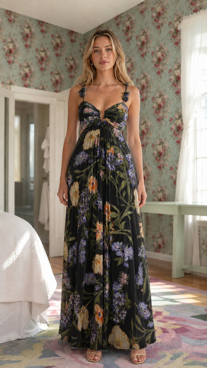 Front view of model wearing black floral pleated maxi dress