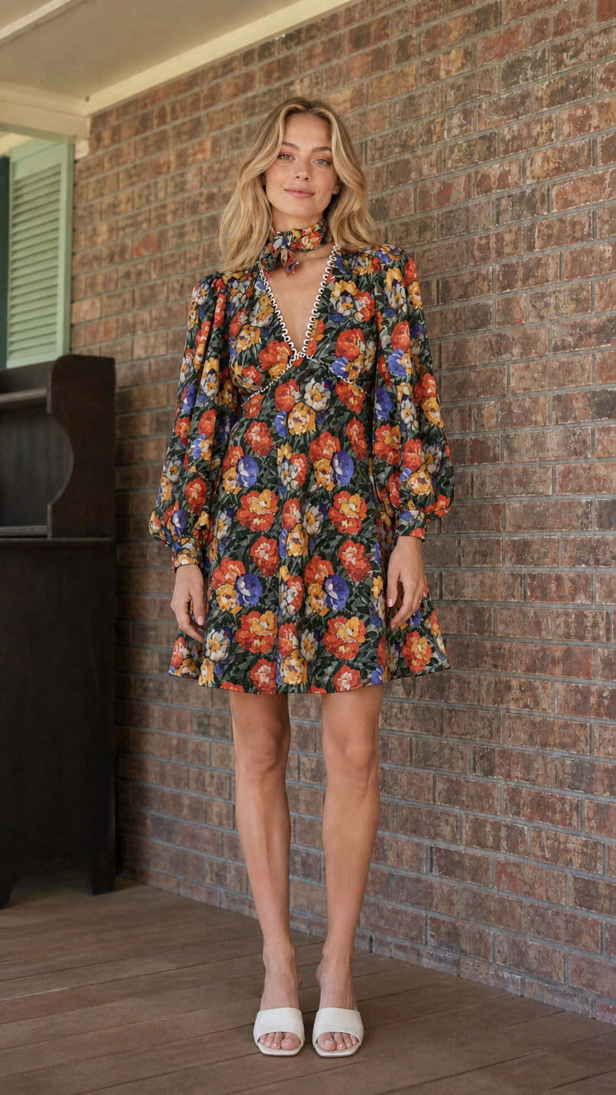 Model wearing black floral print mini dress