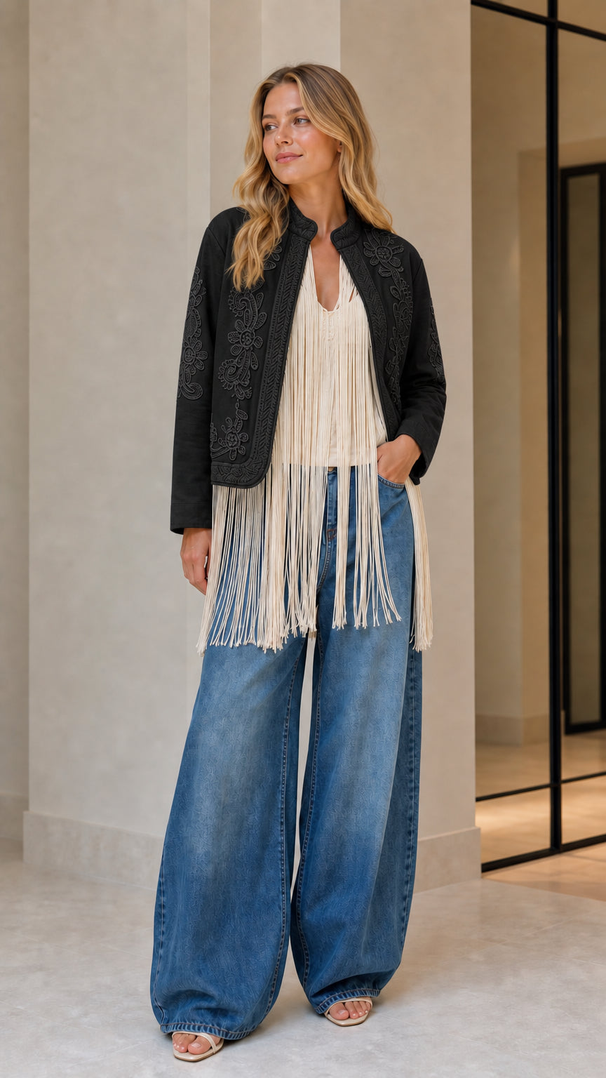 Model wearing black embroidered fringe jacket
