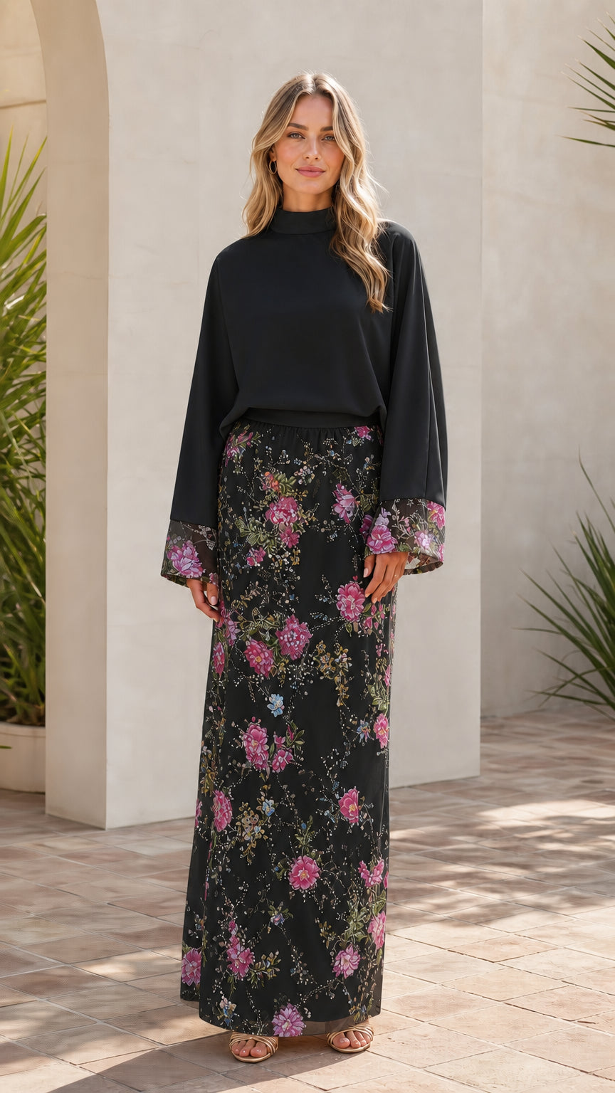 Model wearing black two-piece floral embroidered maxi set