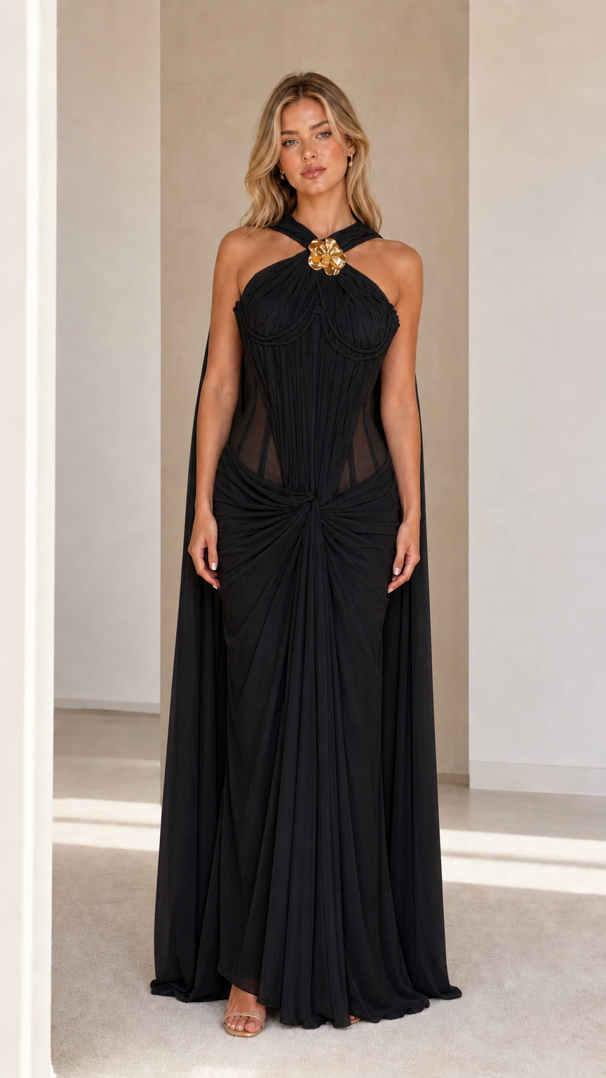 Model wearing black evening cape maxi dress
