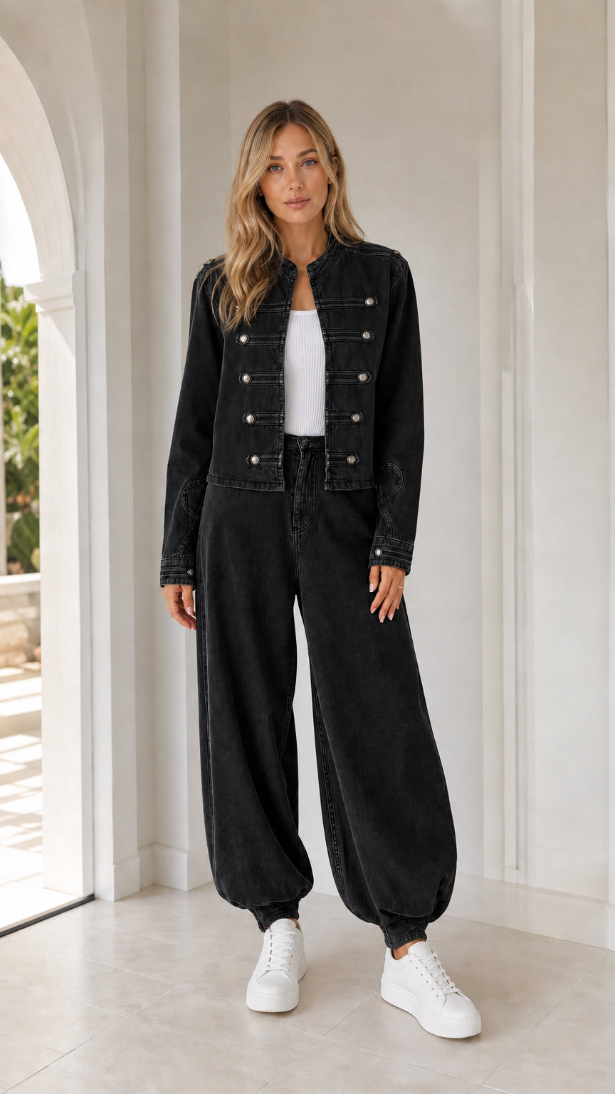 Front full view of woman wearing black utility jacket and matching pants
