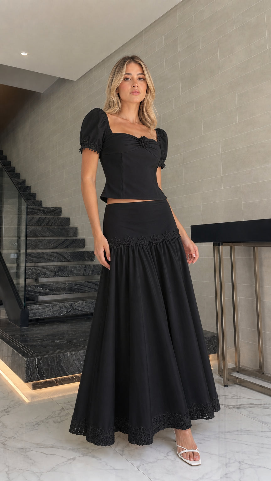 Model wearing black puff sleeve crop top and maxi skirt set