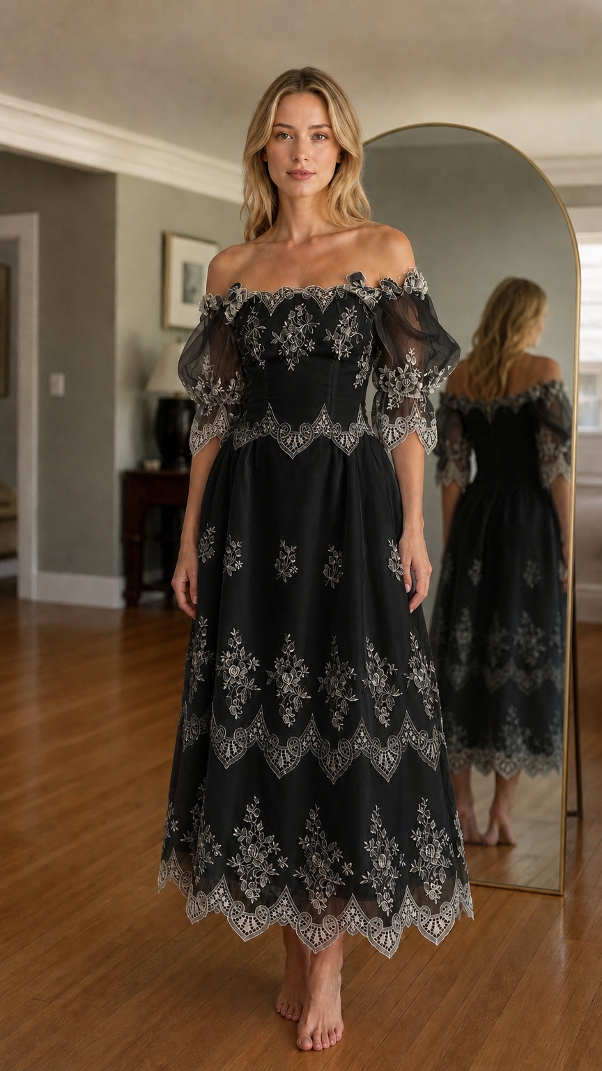 Woman wearing black off-shoulder embroidered midi dress